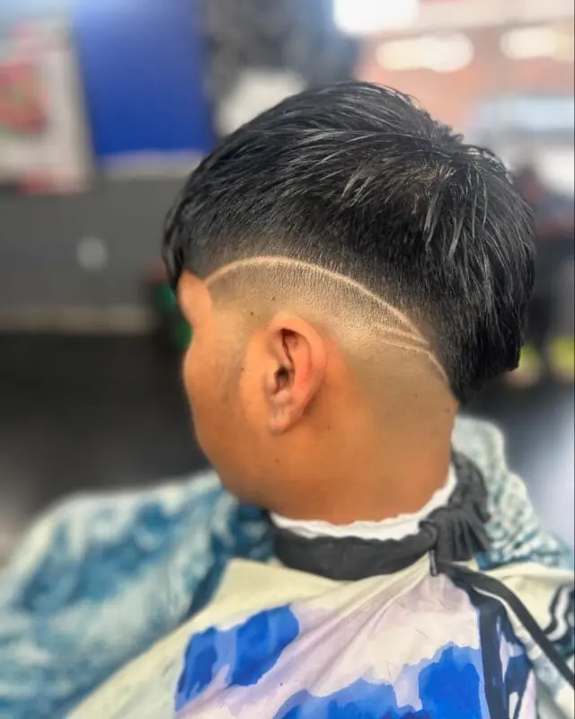 Taper fade with a curved part line